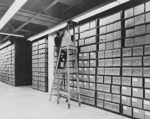 An employee services records in the Washington National Records Center stack area. Conducting historical research taught Stephanie Fulbright the skills to analyze varied sources and produce comprehensible results. US National Archives